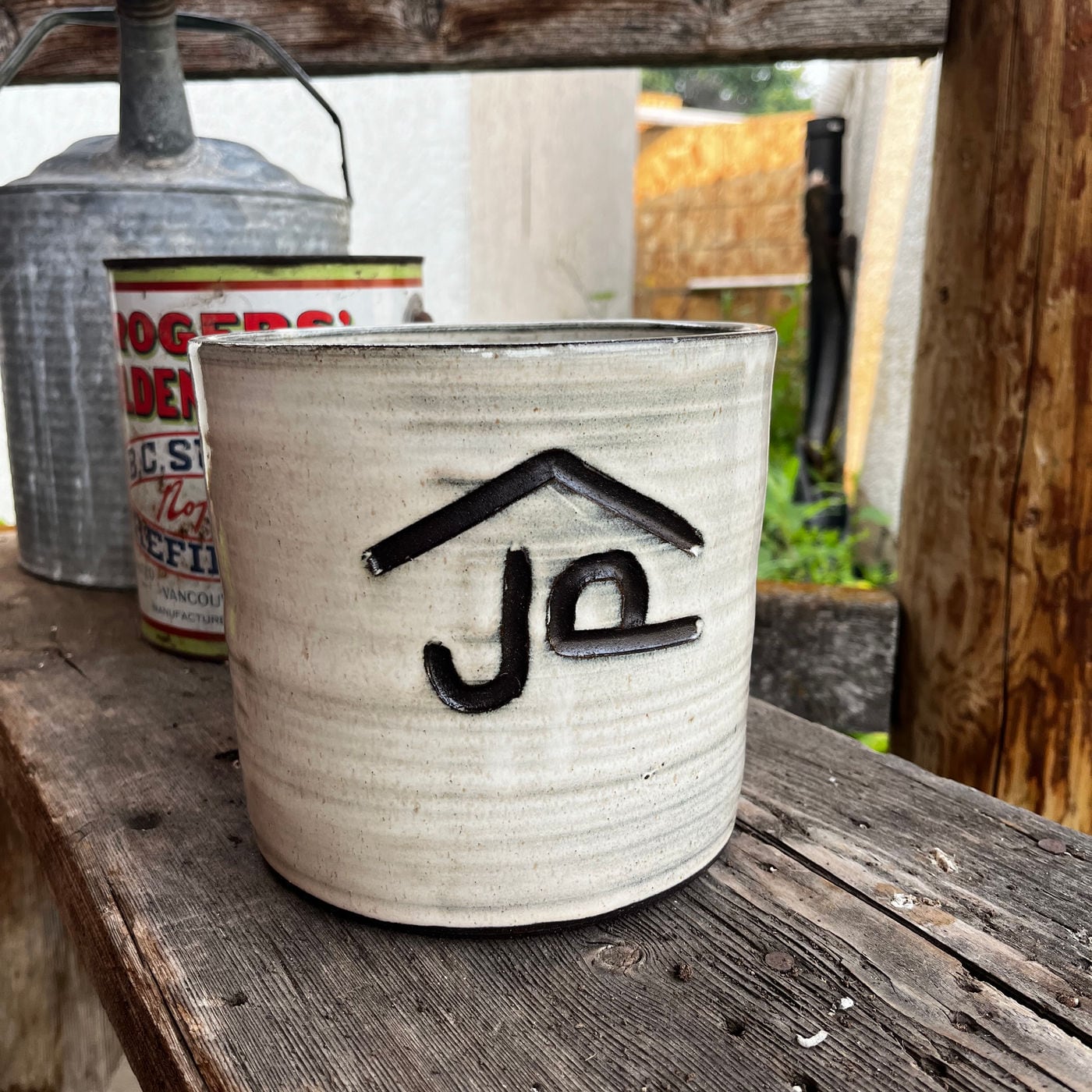A mug with a cattle brand carved into it by hand