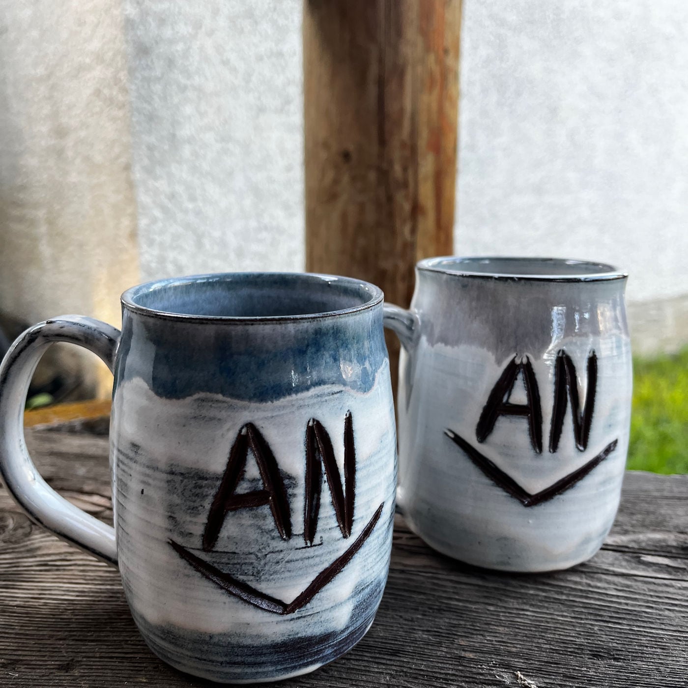 A mug with a cattle brand carved into it by hand